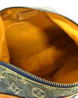 Interior of a Louis Vuitton Monogram Denim Baggy PM bag with yellow Alcantara lining and open compartment.