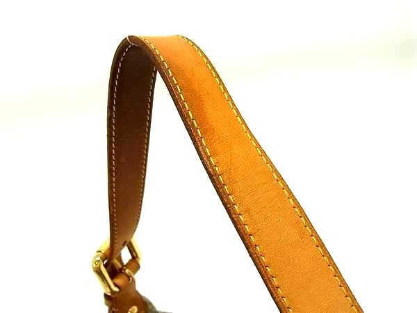 Close-up of the tan leather shoulder strap with yellow stitching and gold hardware on a Louis Vuitton Baggy PM.