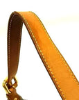 Close-up of the tan leather shoulder strap with yellow stitching and gold hardware on a Louis Vuitton Baggy PM.