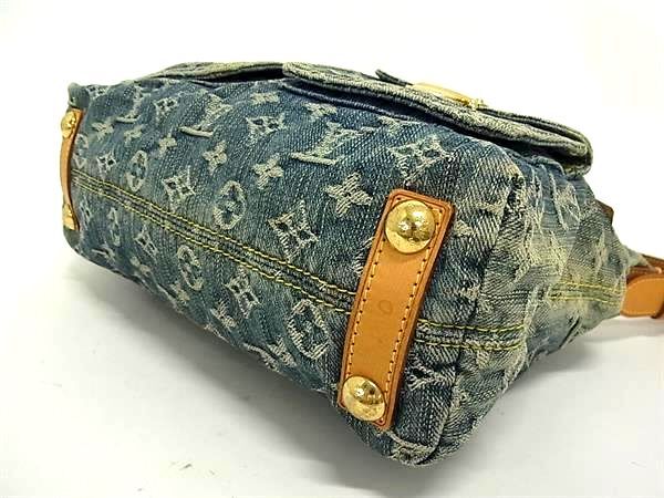 Bottom view of Louis Vuitton Monogram Denim Baggy PM featuring vachetta leather trim and gold-tone studs.