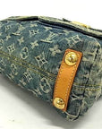 Bottom view of Louis Vuitton Monogram Denim Baggy PM featuring vachetta leather trim and gold-tone studs.