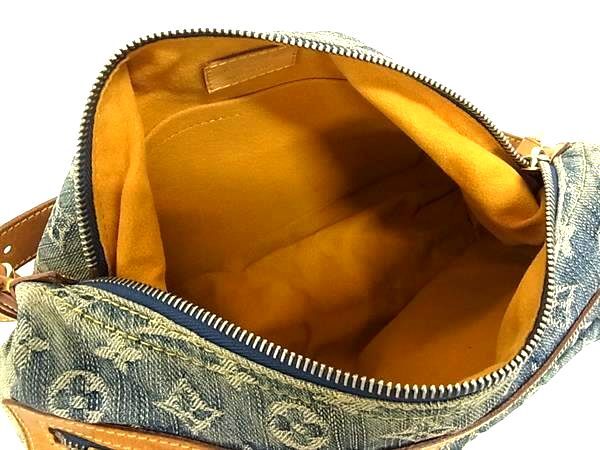 Interior of a Louis Vuitton Monogram Denim Baggy PM bag with yellow Alcantara lining and open compartment.