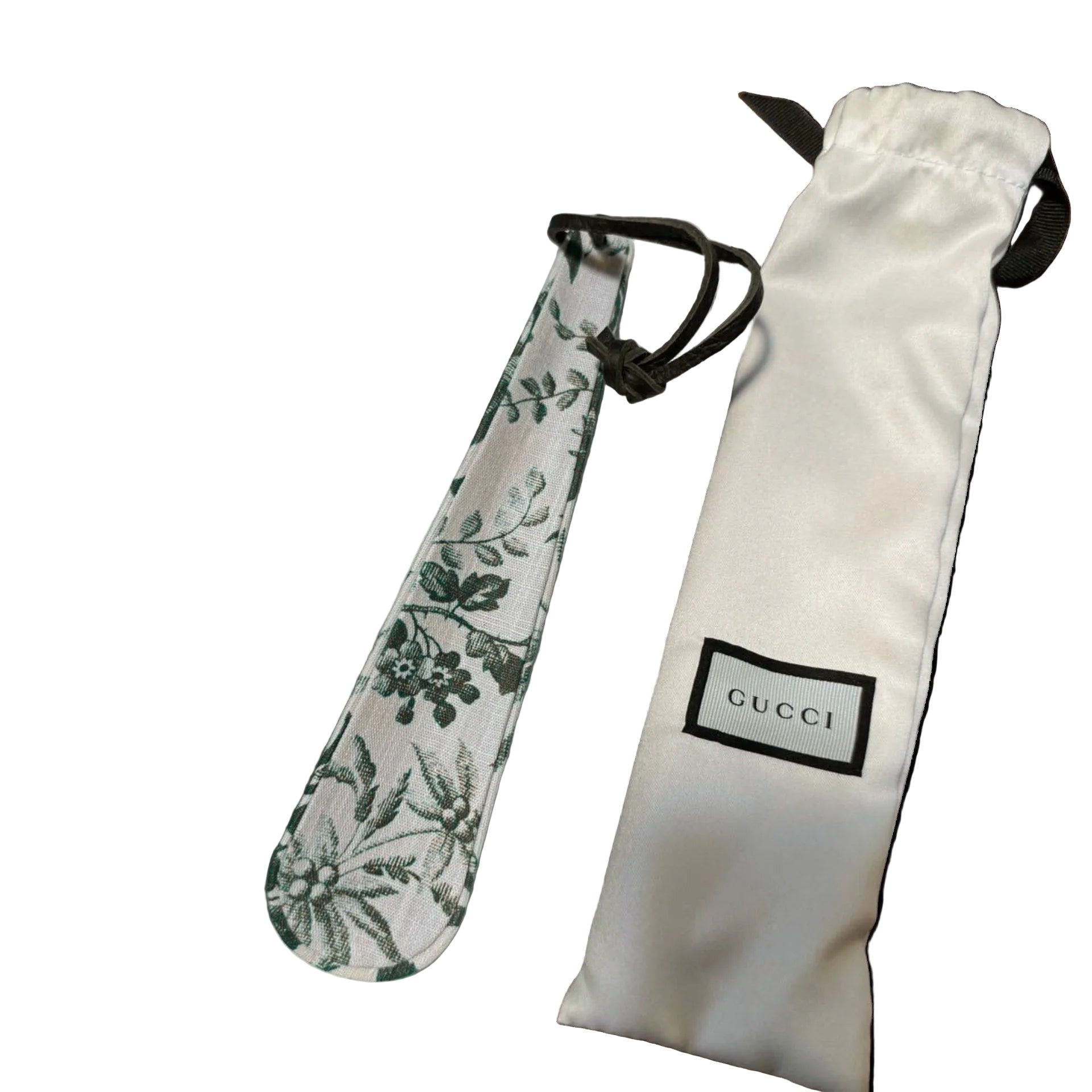 GUCCI Herbarium green floral print shoehorn with leather loop and branded white satin dust bag on a white background.